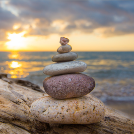 Rocks stacked in front of Sunset