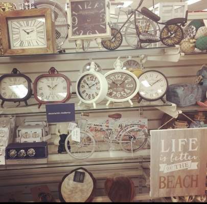 Clocks and a sign that says "Life is better at the beach"